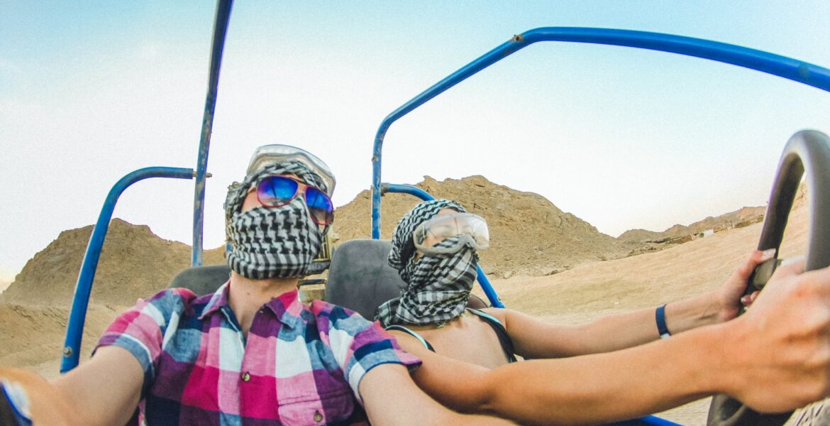 A couple driving a safari vehicle