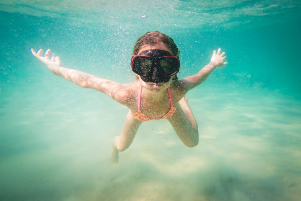 His child dives with dolphins