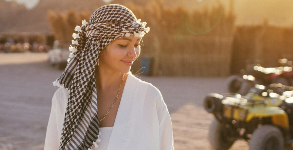 A girl in the desert wearing a headdress