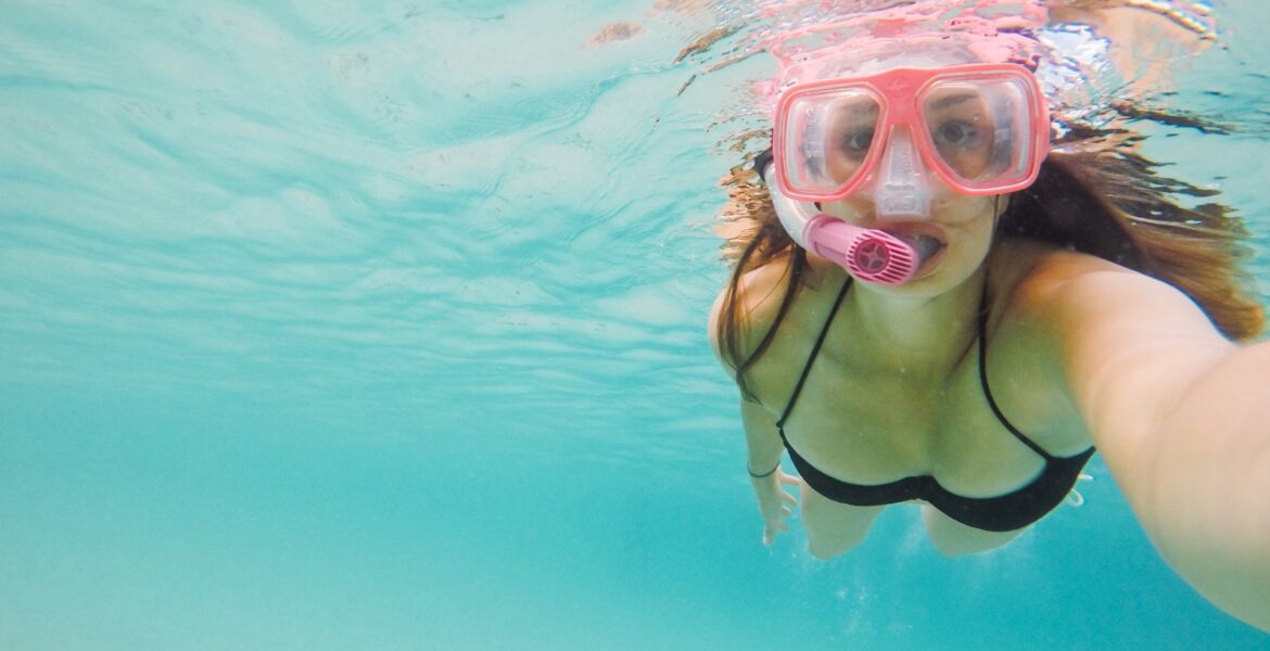 Girl diving wearing diving goggles